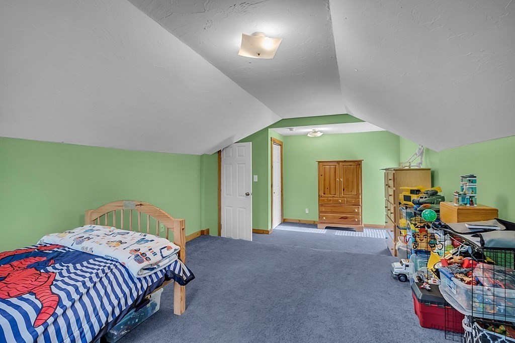 21 River Road Templeton, MA 01436 - Photo 18 of 26 a bedroom with a bed and a chandelier