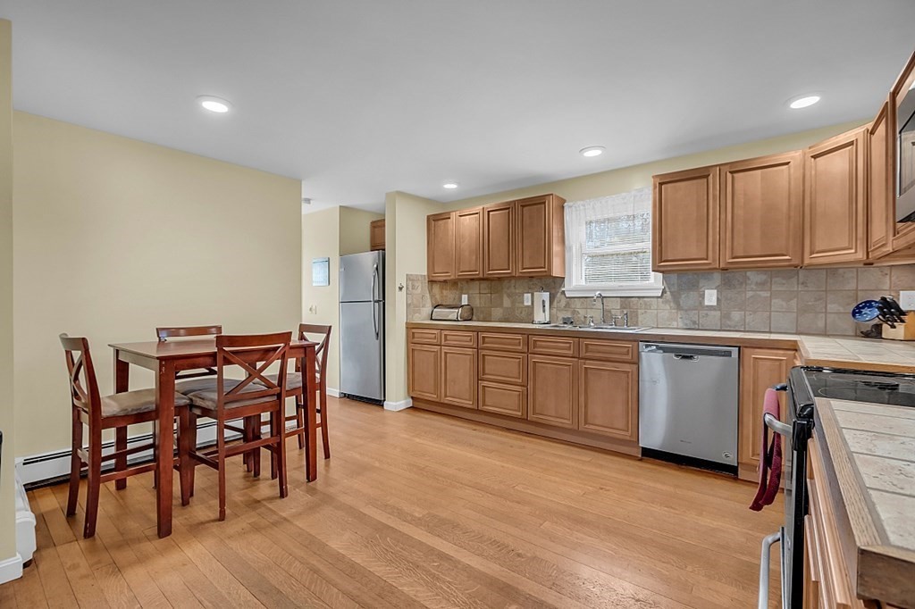 21 River Road Templeton, MA 01436 - Photo 4 of 26 a kitchen with a table a sink appliances and cabinets