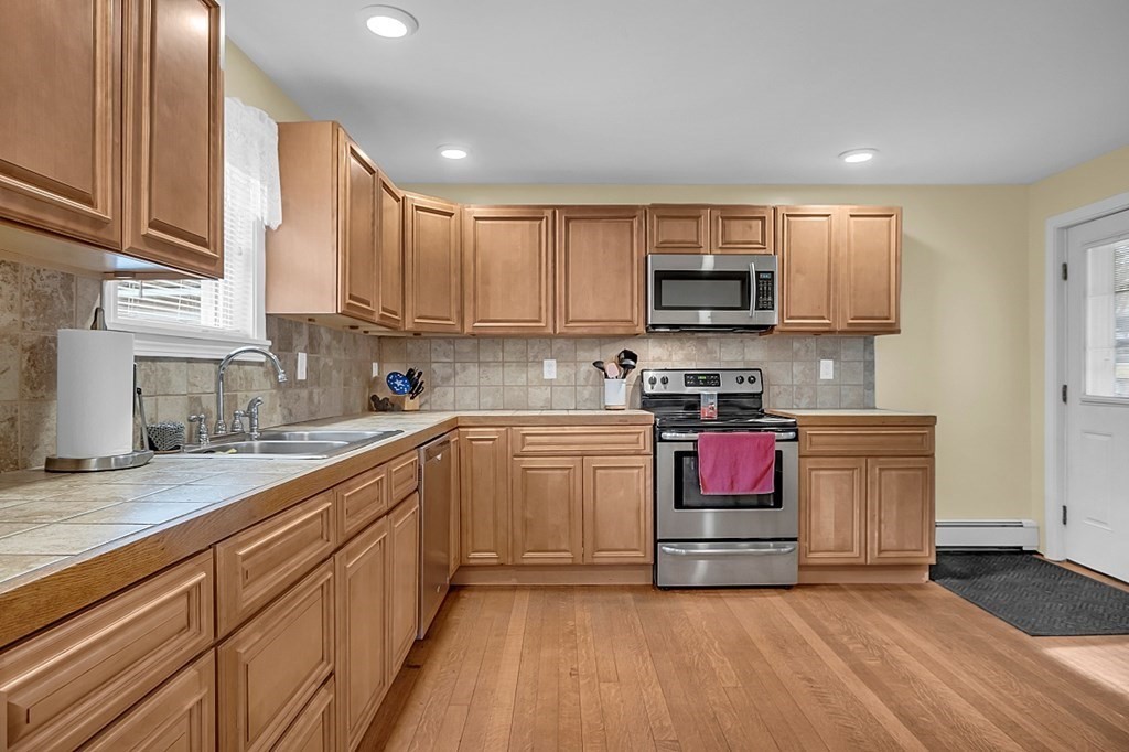 21 River Road Templeton, MA 01436 - Photo 5 of 26 a kitchen with stainless steel appliances granite countertop a stove a sink and a microwave