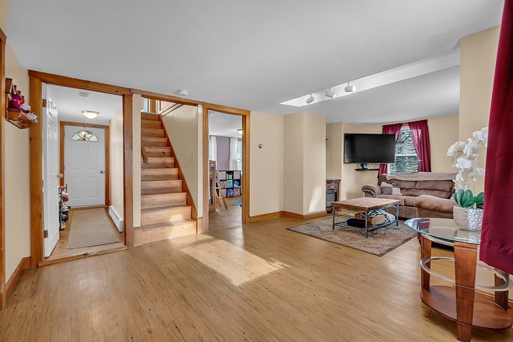 21 River Road Templeton, MA 01436 - Photo 10 of 26 a view of a livingroom with wooden floor and a flat screen tv