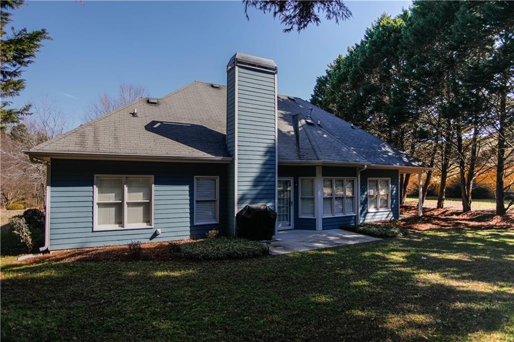 3875 Spring Manor Court Loganville, GA 30052 - Photo 4 of 23 a front view of a house with a garden