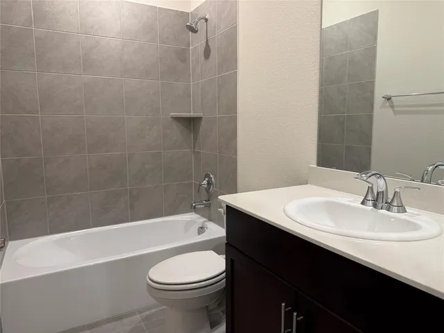 a bathroom with a sink a toilet and bathtub