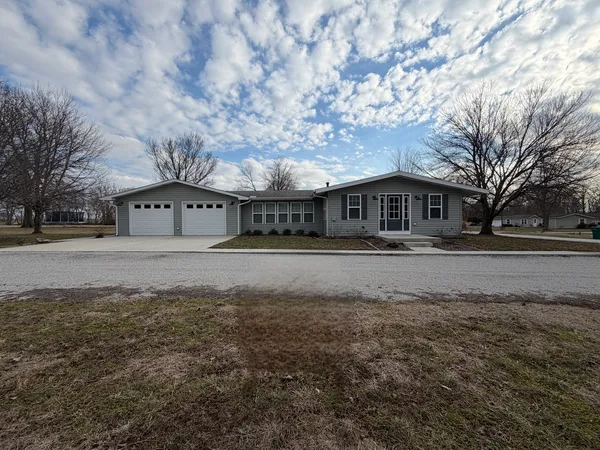 a view of house with a yard