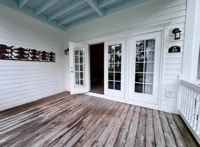 a view of a house with wooden deck