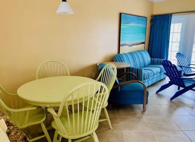 a living room with a chairs and a table