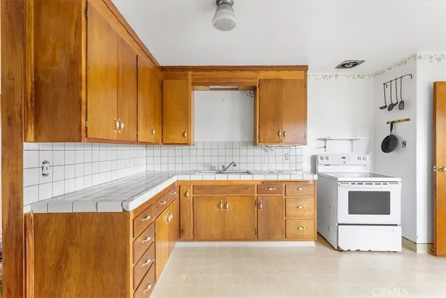 a kitchen with stainless steel appliances granite countertop a sink and cabinets