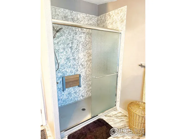 a bathroom with a shower and a sink