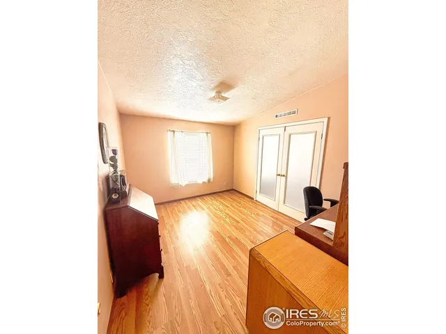 a bedroom with a bed and a lamp on table