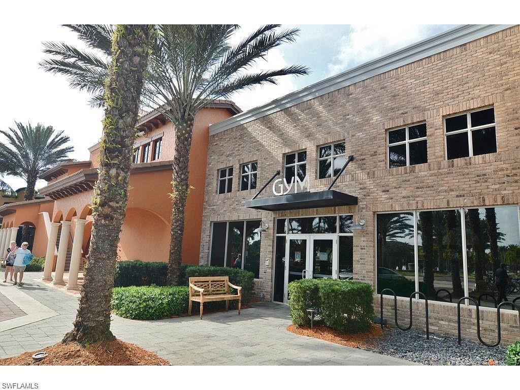 8997 Cambria Circle, Unit 2002 Naples, FL 34113 - Photo 11 of 35 a front view of a house with garden