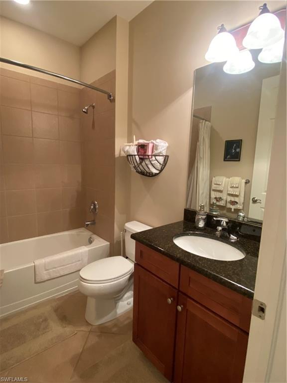 8997 Cambria Circle, Unit 2002 Naples, FL 34113 - Photo 31 of 35 a bathroom with a sink a toilet a mirror and shower