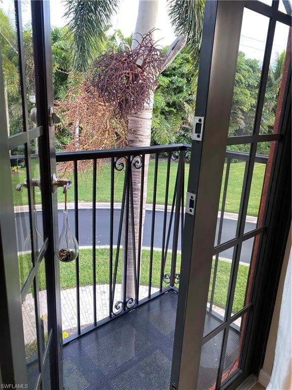 8997 Cambria Circle, Unit 2002 Naples, FL 34113 - Photo 33 of 35 a view of a porch with a floor to ceiling window