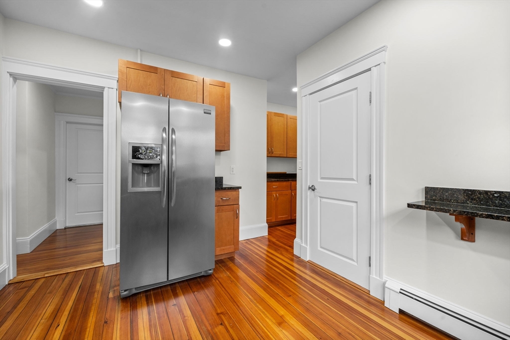 37 Fountain Road, Unit 1 Arlington, MA 02476 - Photo 11 of 19 a kitchen with stainless steel appliances a refrigerator and a stove top oven
