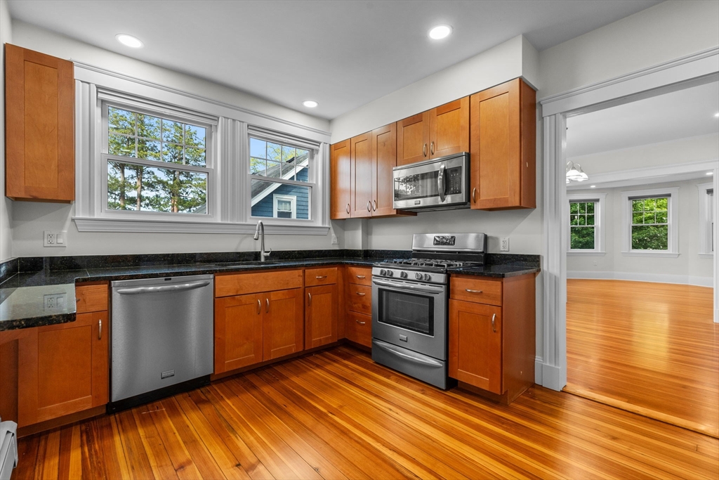 37 Fountain Road, Unit 1 Arlington, MA 02476 - Photo 9 of 19 a kitchen with stainless steel appliances granite countertop a stove a sink and a microwave