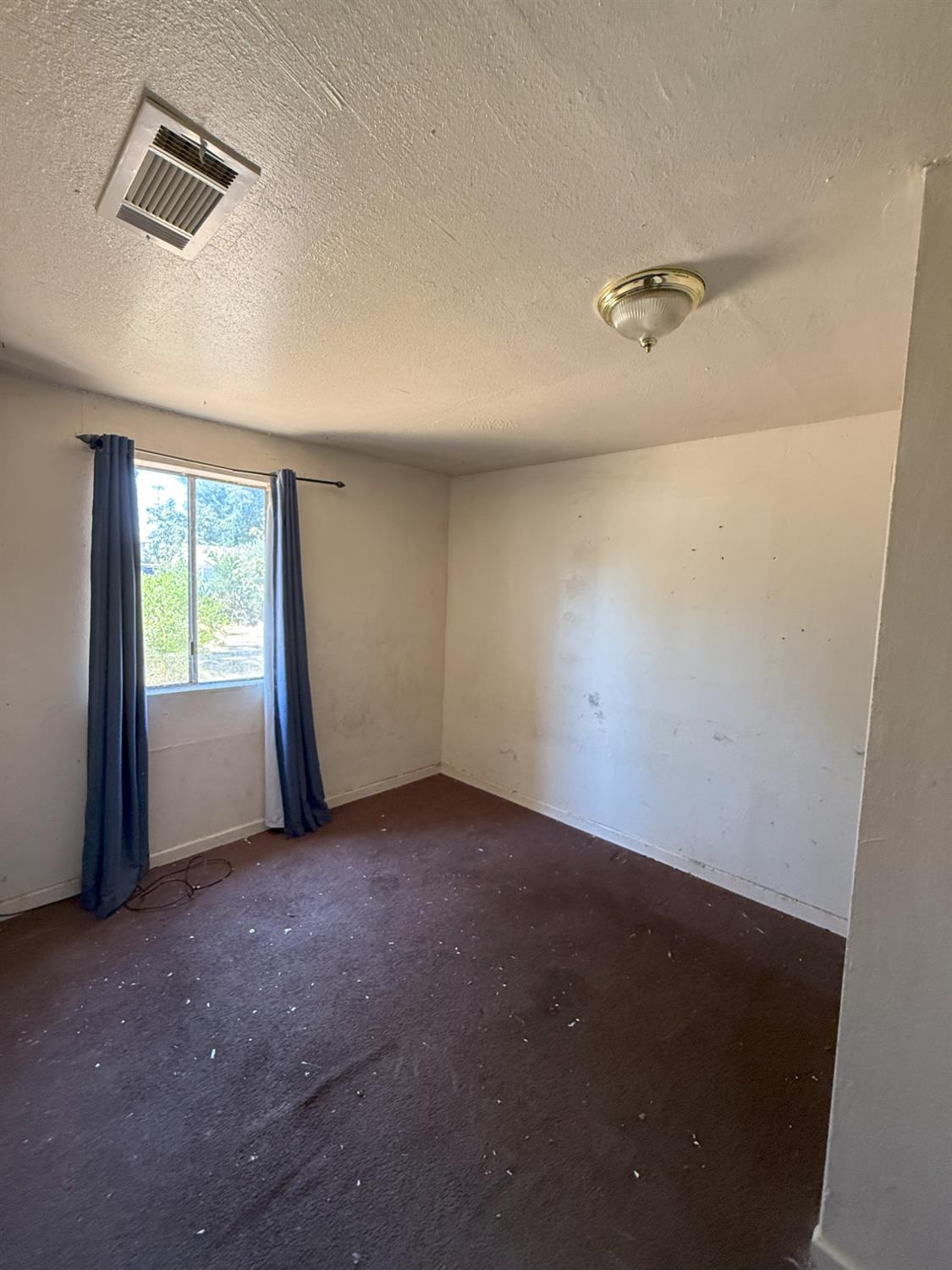 4021 Anna Avenue Keyes, CA 95328 - Photo 6 of 25 an empty room with windows