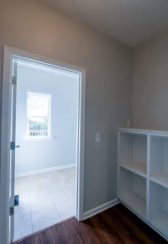 an empty room with wooden floor and closet