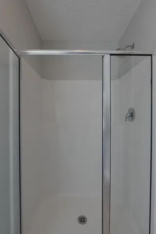 a bathroom with a glass shower door