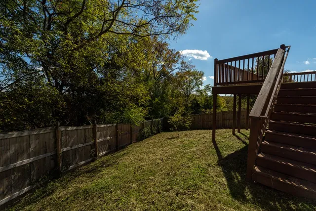 a view of balcony with wooden floor and fence
