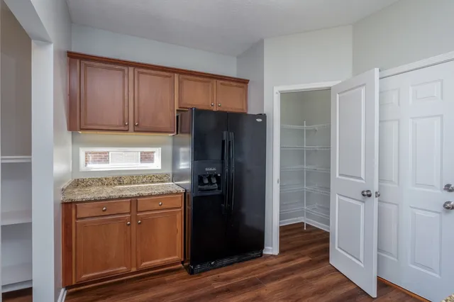 a kitchen with a refrigerator and cabinets