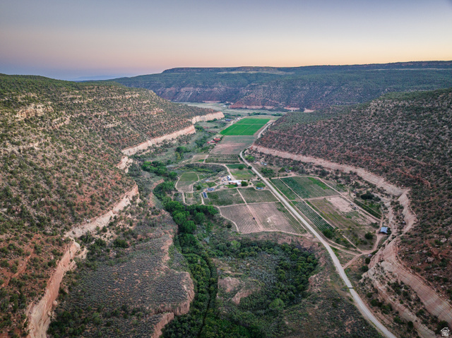 1035 Montezuma Creek Road Monticello, UT 84535 - Photo 1 of 27 Expansive valley property featuring cultivated fields, natural rock formations, and a winding waterway