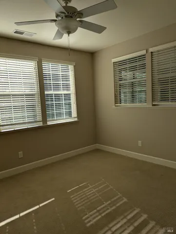 a utility room with wooden floor washer and dryer