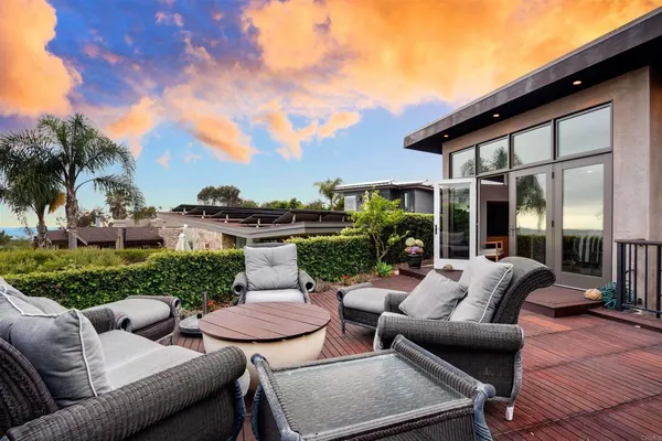a view of a patio with couches chairs and a fire pit