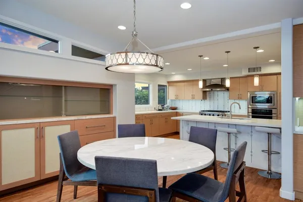 a large kitchen with a table and chairs in it
