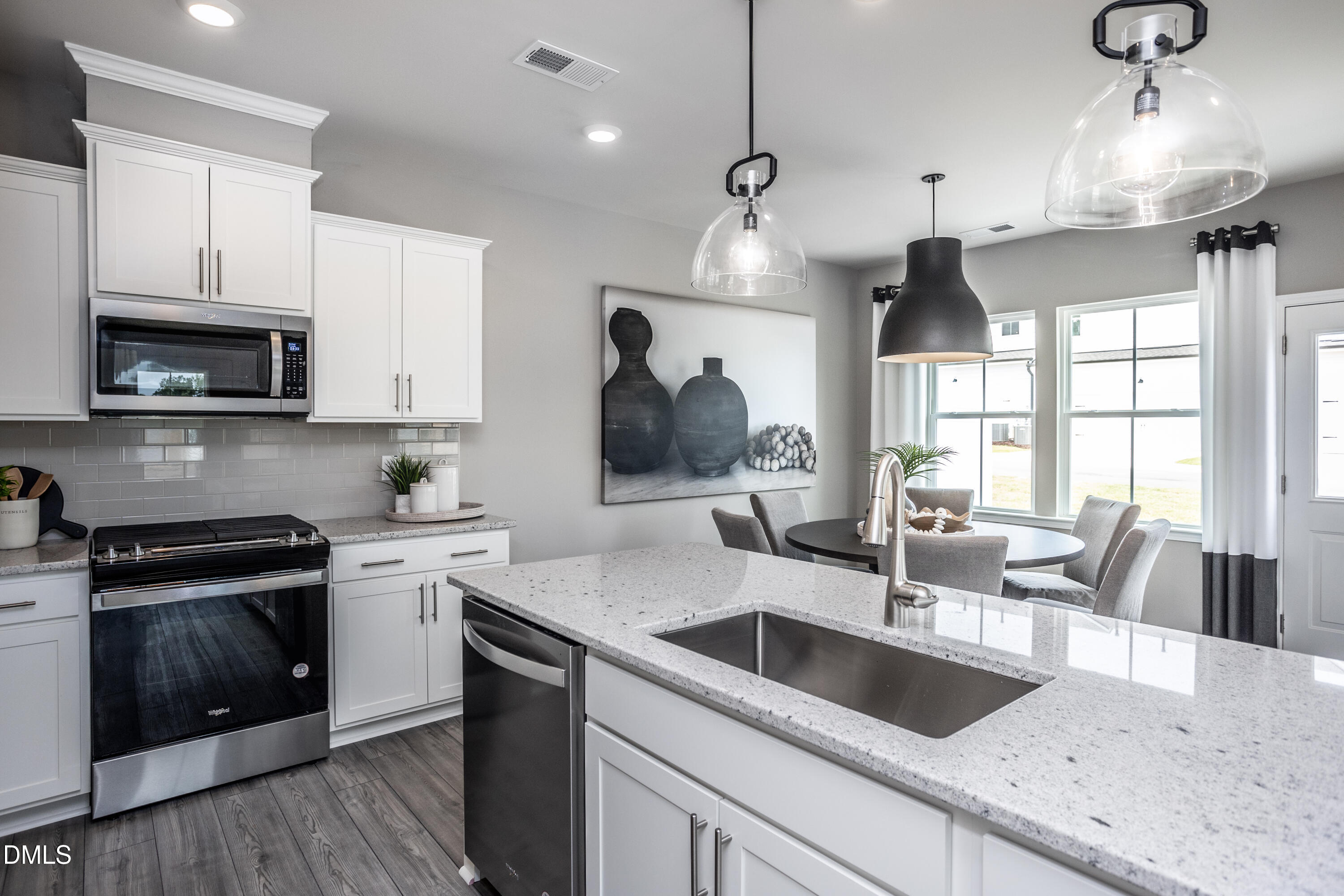 2861 Rodeo Court Fuquay-Varina, NC 27526 - Photo 4 of 24 a kitchen with granite countertop a sink a counter space appliances and cabinets