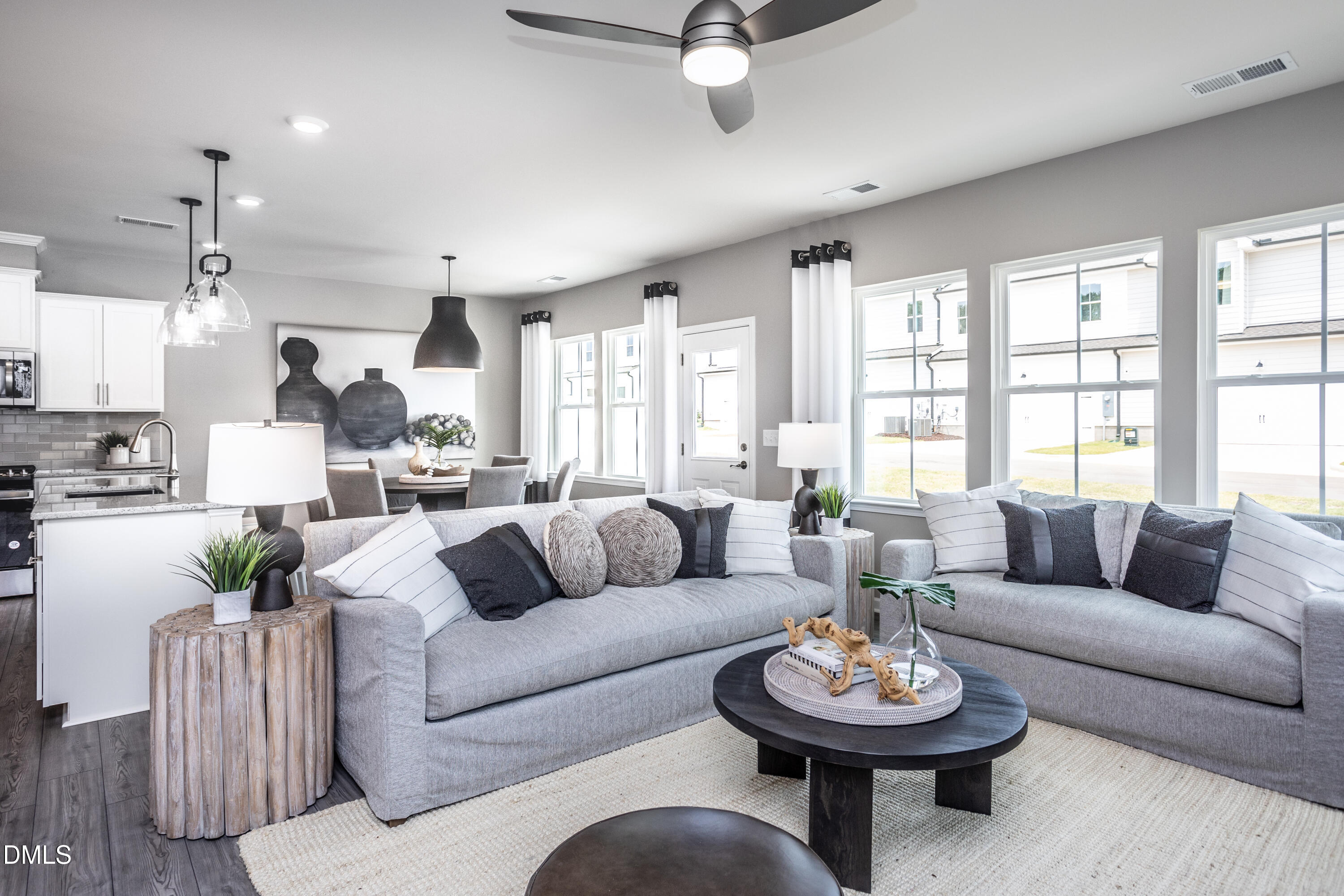 2861 Rodeo Court Fuquay-Varina, NC 27526 - Photo 7 of 24 a living room with furniture a fireplace and a large window