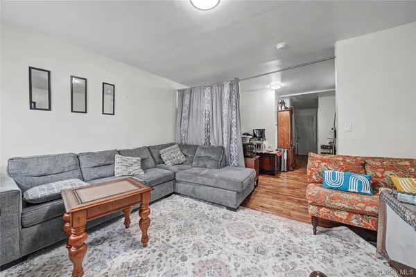 a living room with furniture a rug and a window