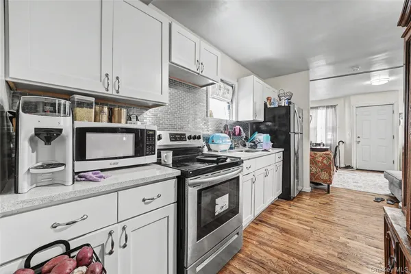 a kitchen with stainless steel appliances granite countertop a stove and cabinets