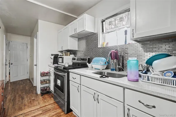 a kitchen with stainless steel appliances a sink stove and cabinets