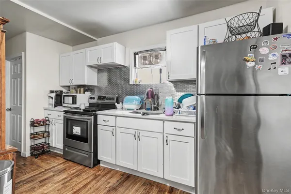 a kitchen with stainless steel appliances granite countertop a refrigerator sink and stove