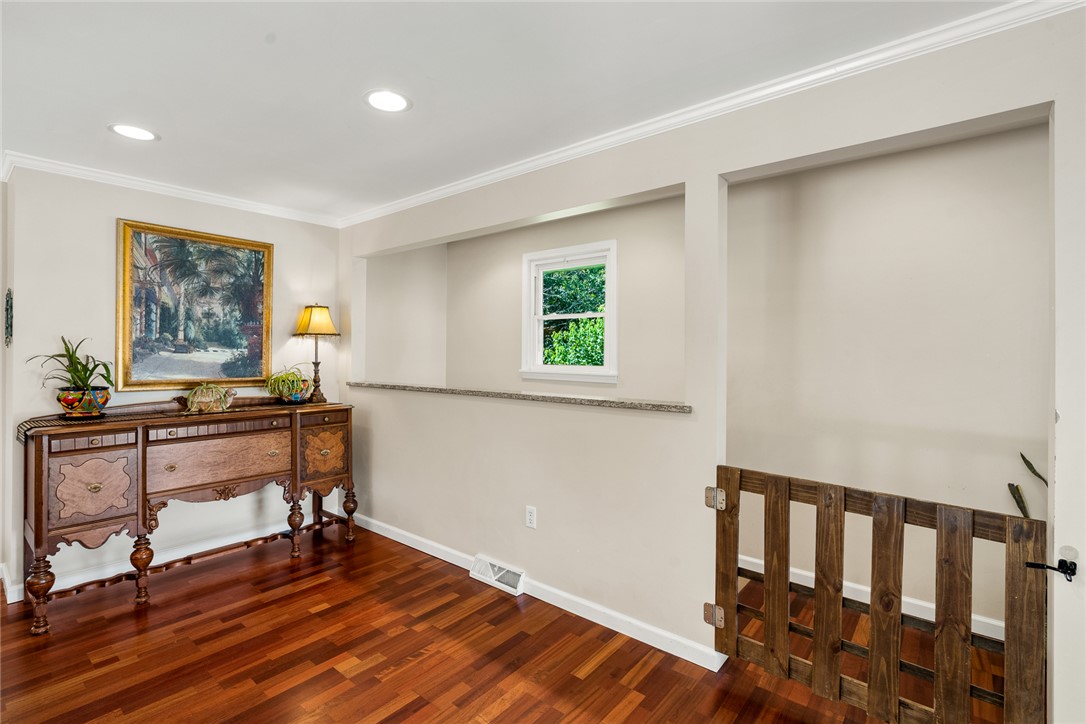 512 East Fredericks Street Anderson, SC 29621 - Photo 21 of 31 Rich hardwood floors complement the warm, inviting ambiance of this versatile interior space.
