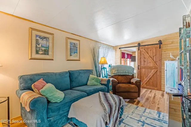 a living room with furniture a couch and a window