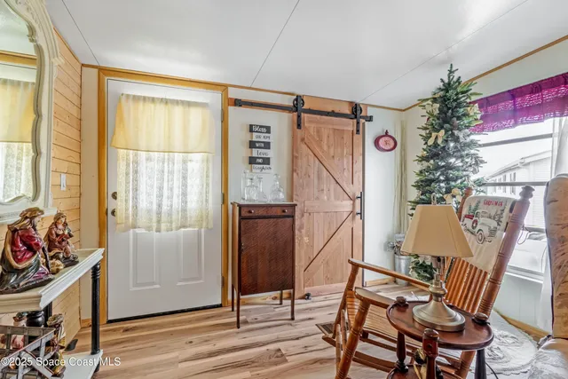 a view of an entryway with wooden floor and windows