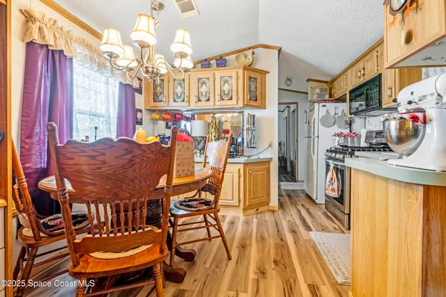 a view of a dining room with furniture and a chandelier
