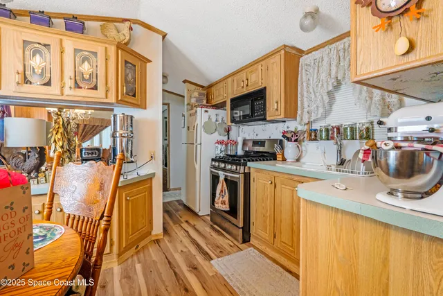 a kitchen with stainless steel appliances granite countertop a sink and cabinets