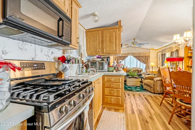a kitchen with stainless steel appliances granite countertop a stove and a sink