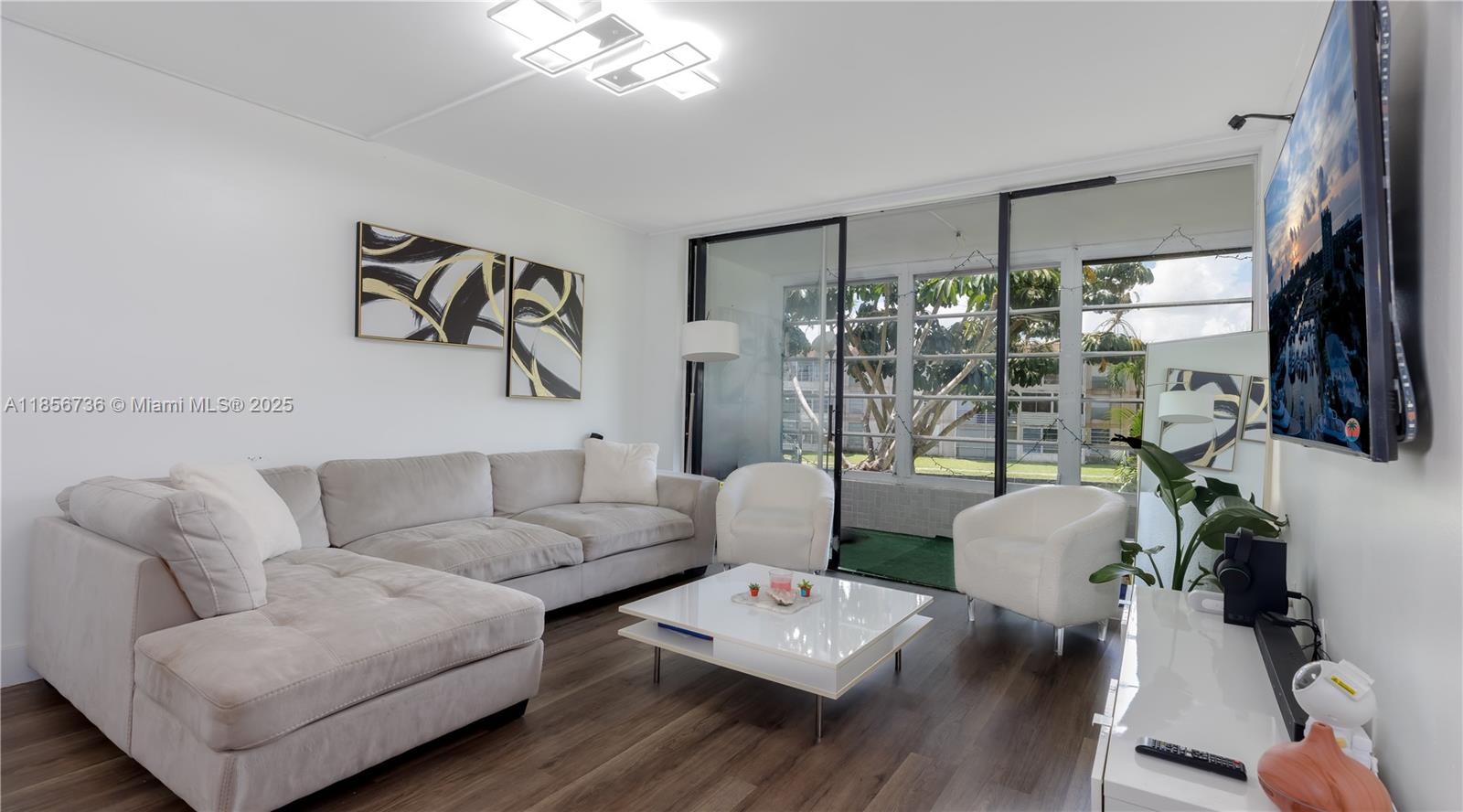 8321 Sands Point Boulevard, Unit D205 Tamarac, FL 33321 - Photo 1 of 18 a living room with furniture and a large window