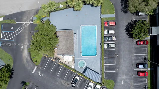 an aerial view of a residential apartment building with a yard and plants