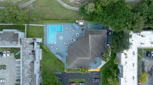 an aerial view of a house with a yard