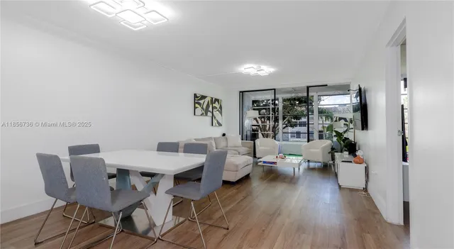 a view of a dining room with furniture wooden floor and a chandelier