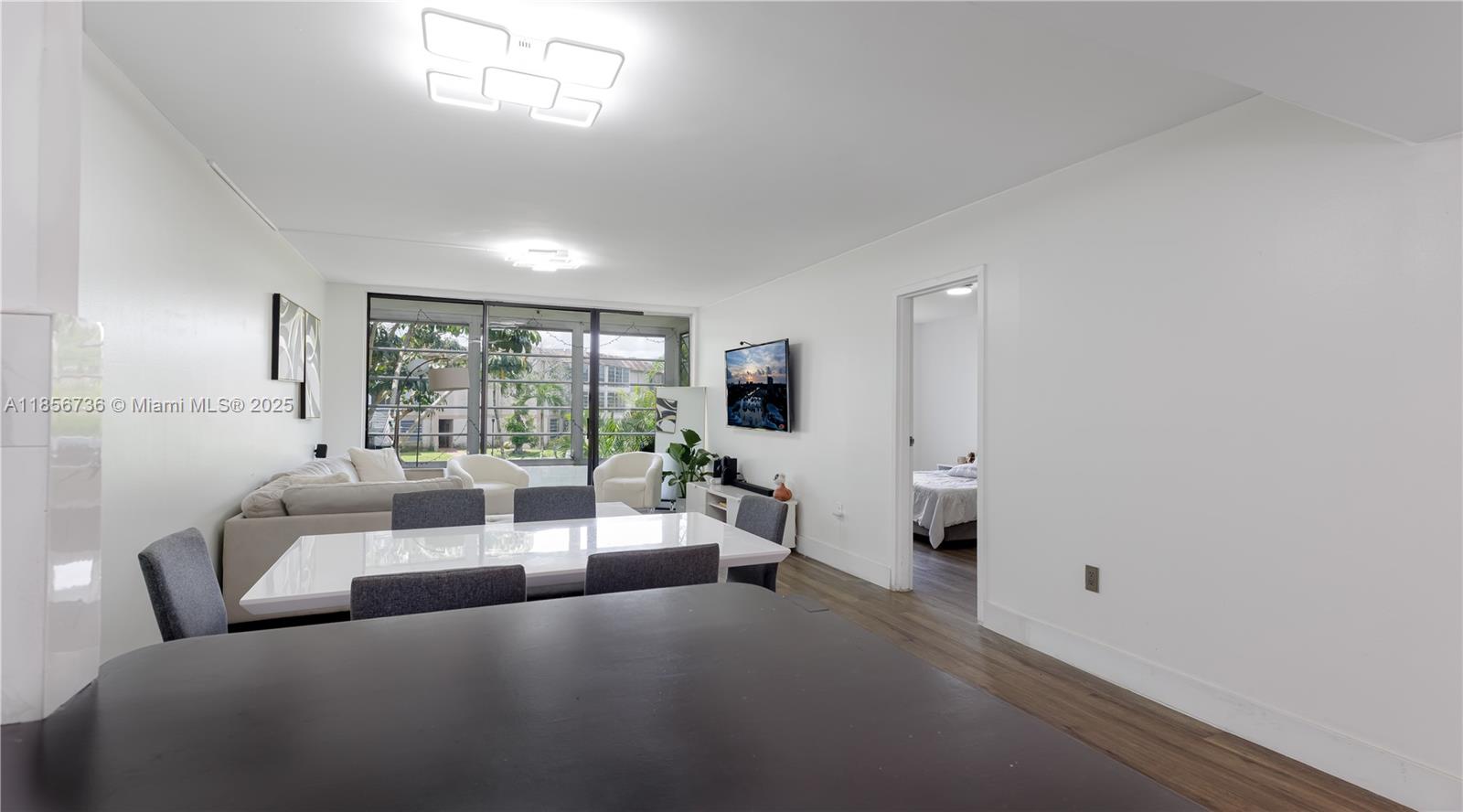 8321 Sands Point Boulevard, Unit D205 Tamarac, FL 33321 - Photo 6 of 18 a living room with furniture and a large window
