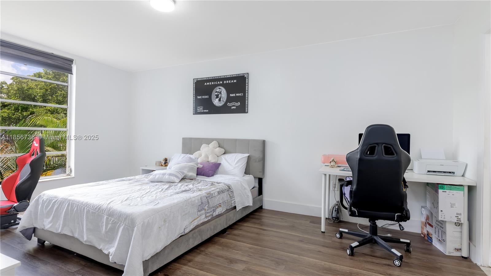 8321 Sands Point Boulevard, Unit D205 Tamarac, FL 33321 - Photo 8 of 18 a bedroom with a bed and a window