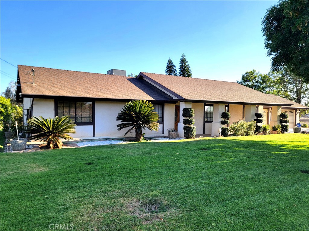 10170 60th Street Riverside, CA 92509 - Photo 22 of 24 a front view of a house with a garden