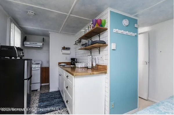 a kitchen with stainless steel appliances granite countertop a refrigerator a stove and a sink