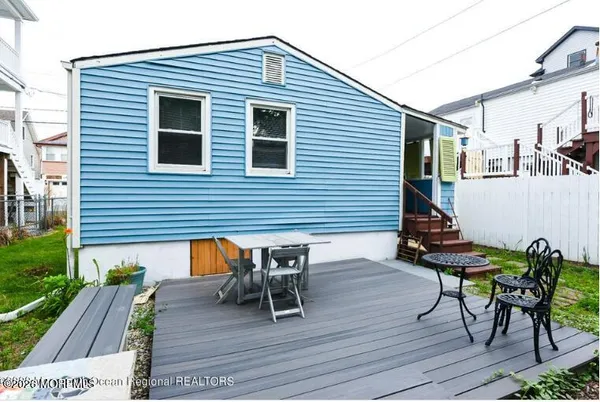 a view of a dinning table and chairs in patio of the house