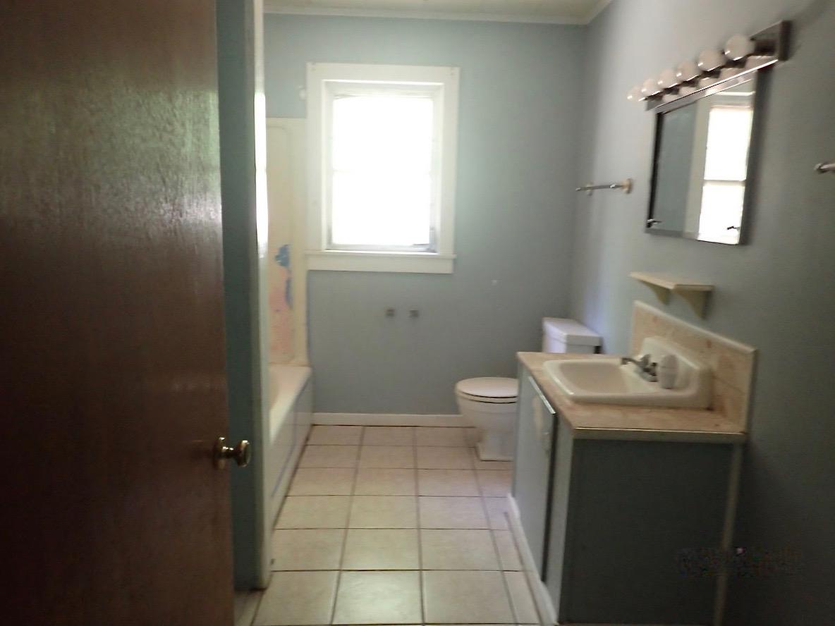 1088 Mapoles Street Crestview, FL 32536 - Photo 5 of 6 a bathroom with a sink toilet and mirror