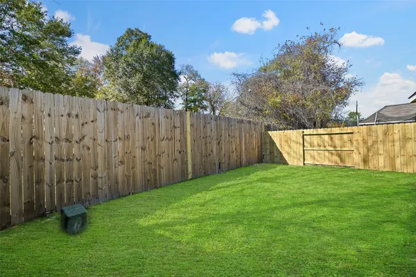 a view of a backyard with wooden fence