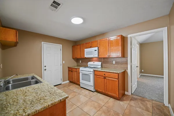 a kitchen with a stove top oven and sink